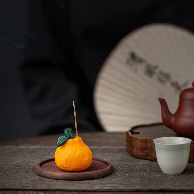 Ceramic Orange Incense Burner on wooden tray for aromatherapy
